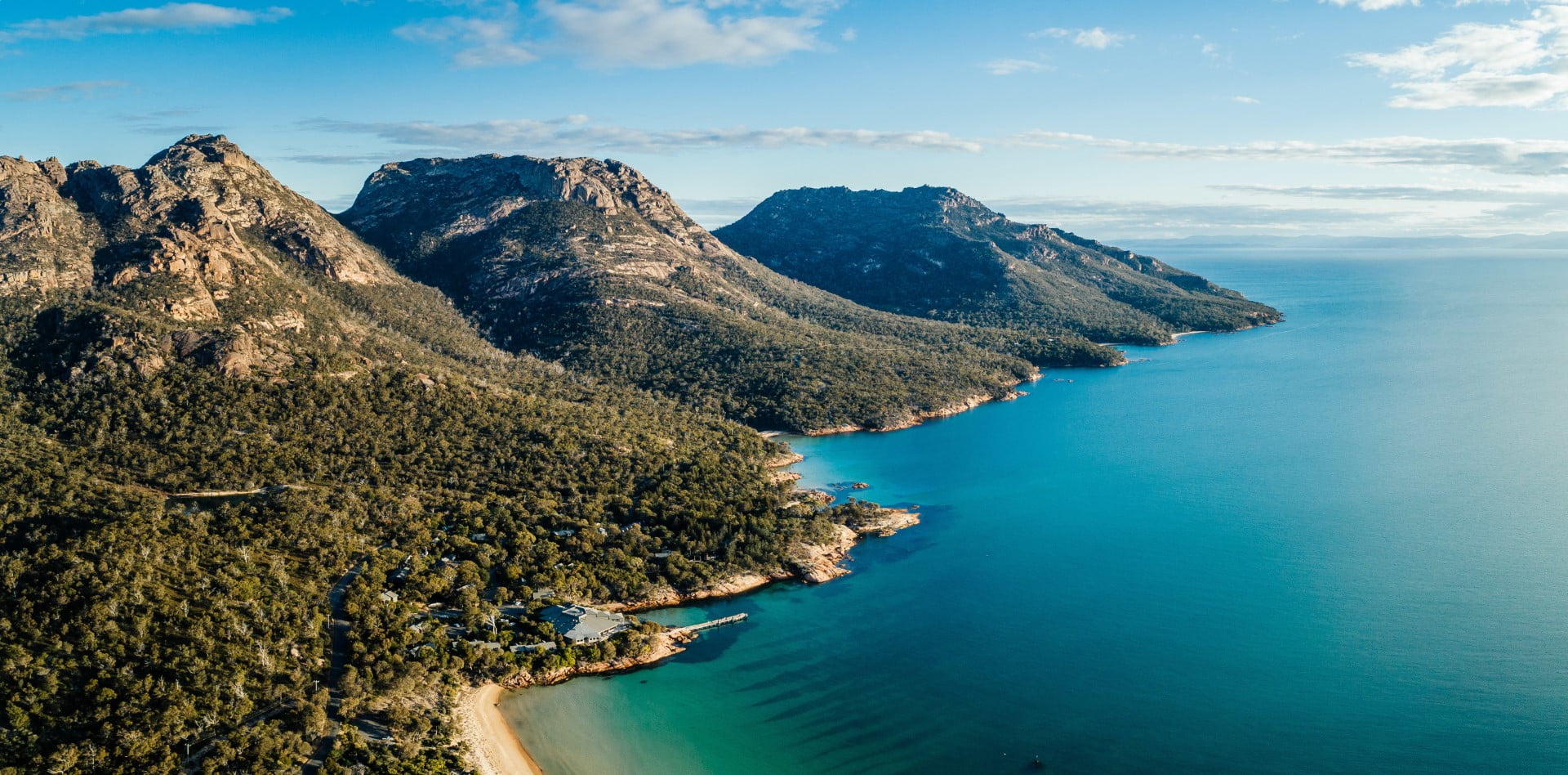 Freycinet Lodge, nestled into the bushland, sea to the south and mountains to the north.