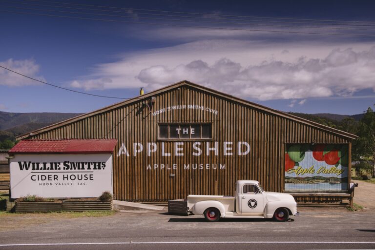 Wilie smiths historic apple shed, vertical slat timber construction with a classic ute parked out front.