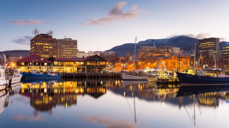 Hobart waterfront, at dusk, showing the city marina and skyline with Mt Wellington in the background