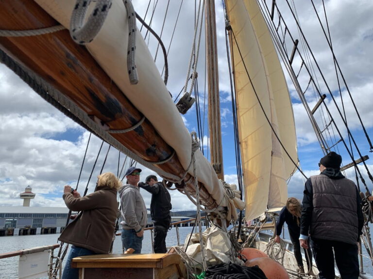 Crew and tourists preparing to sail from the Hobart marina aboard the S.V. Rhona wooden boat.